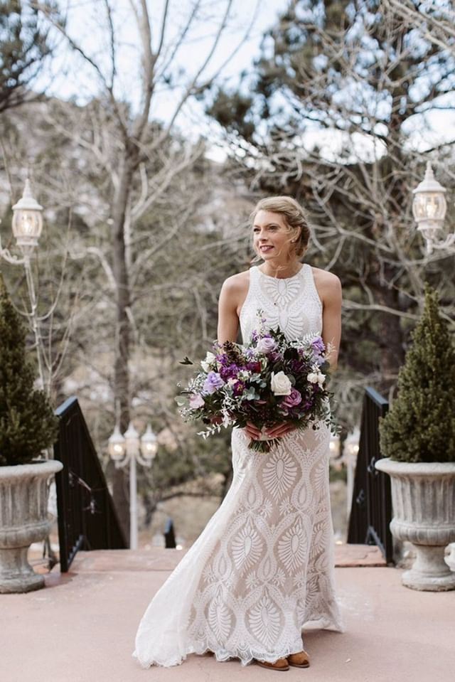 Model wearing a white gown with a flowers