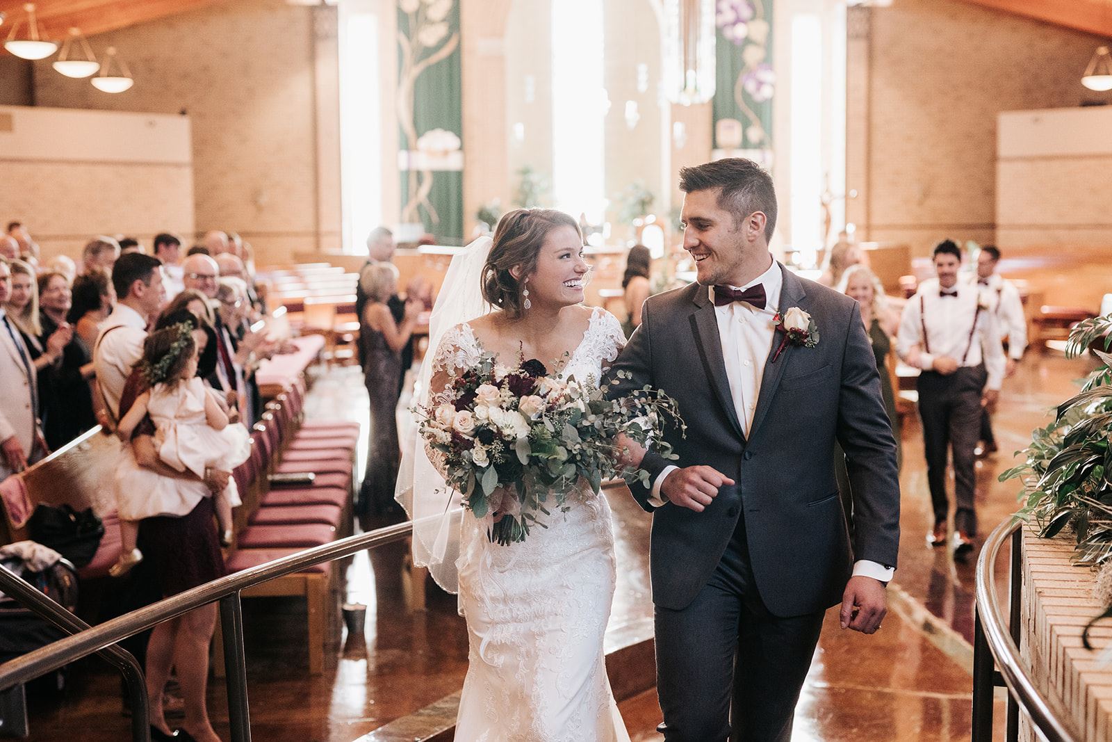 Сouple wearing a white gown and a black suit