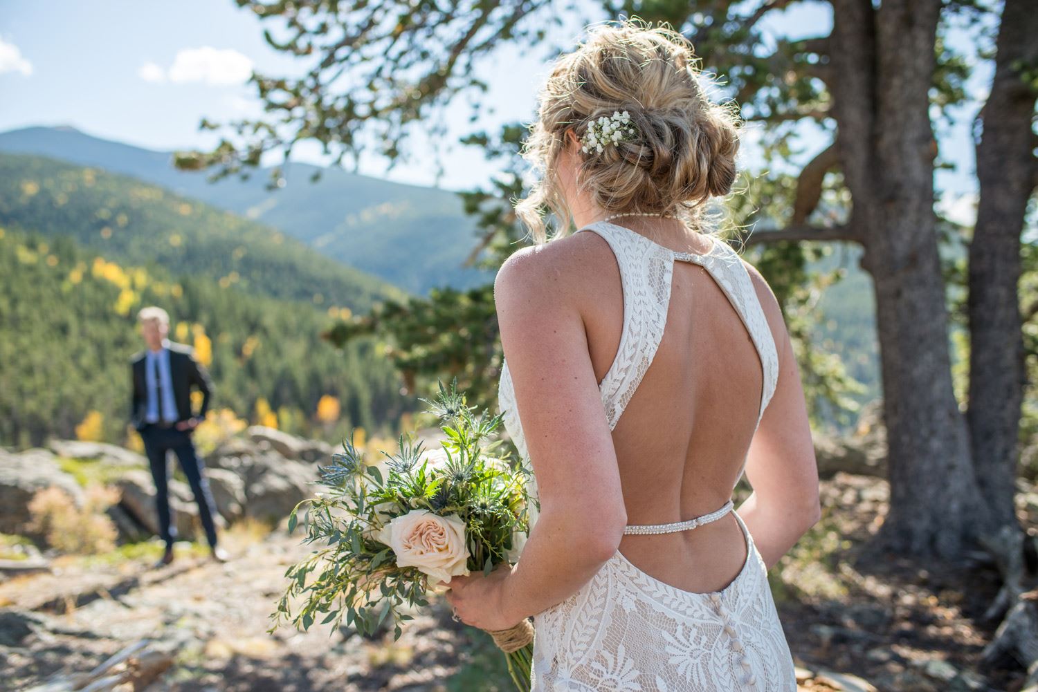 Сouple wearing a white gown and a black suit in the wood