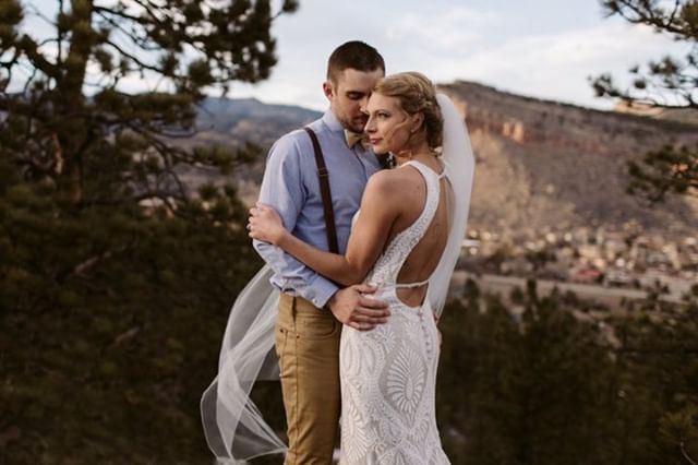 Сouple wearing a white gown and a light suit