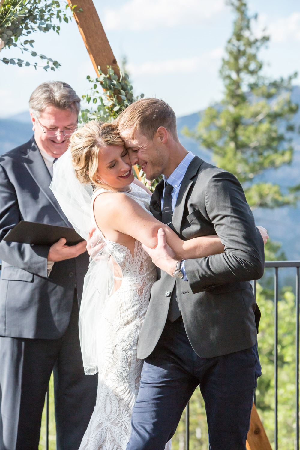 Сouple wearing a white gown and a dark-gray suit